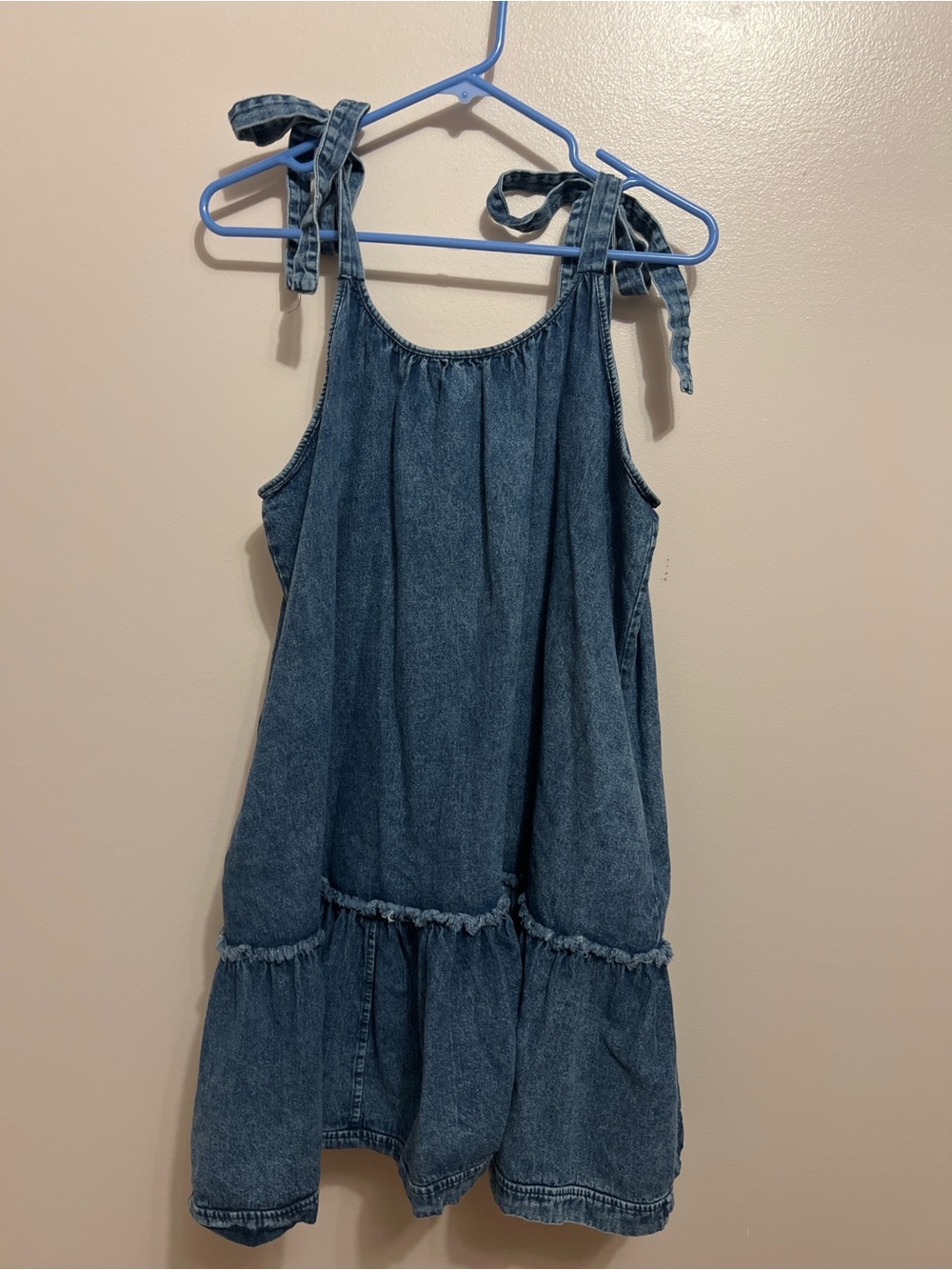 Medium wash denim mini dress with adjustable tie shoulder straps